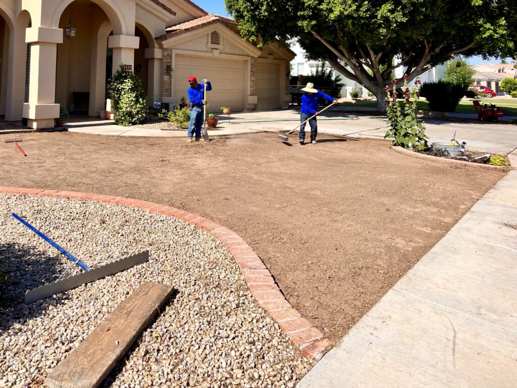 artificial-turf-insatall-2 Installing base layer and aligning turf sections for synthetic grass installation in Chandler AZ